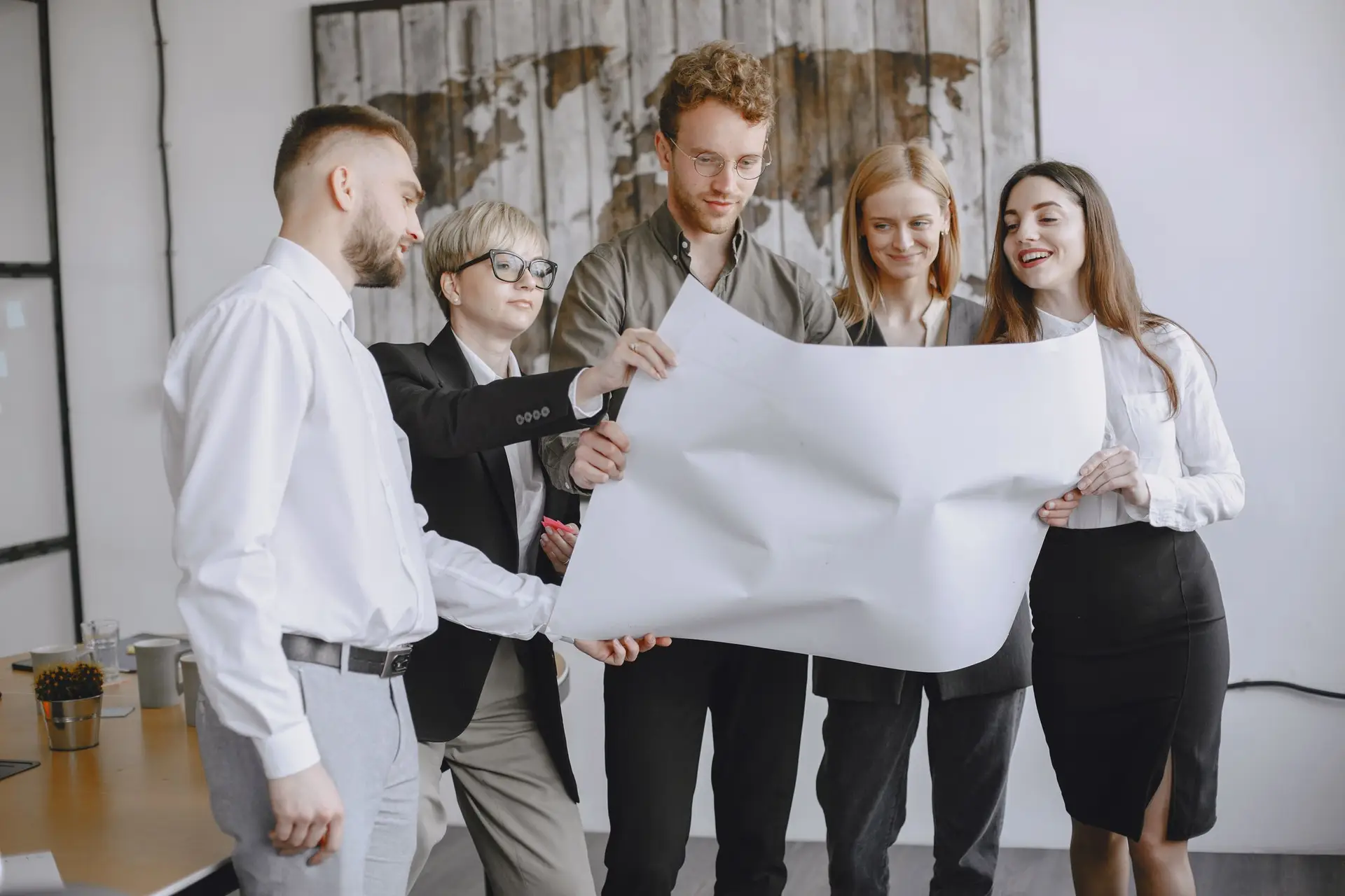 A group reviewing project plans together around an office table